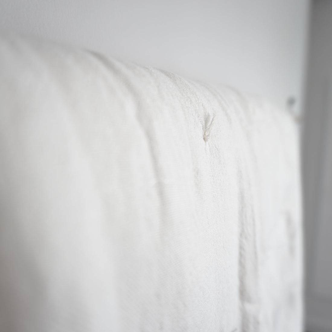close up of white linen quilt