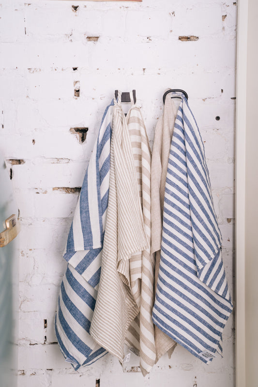 several linen fabric hanging from hook on the wall