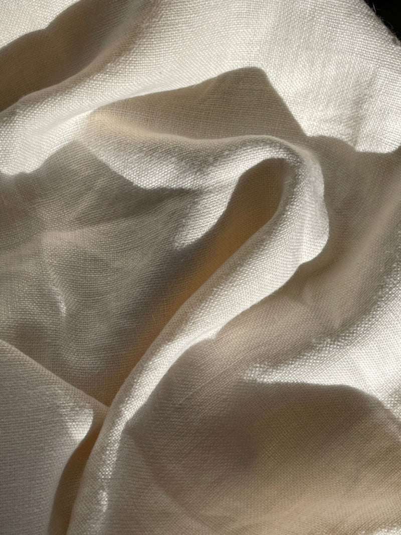 Close-up of beige fabric with folds and shadows